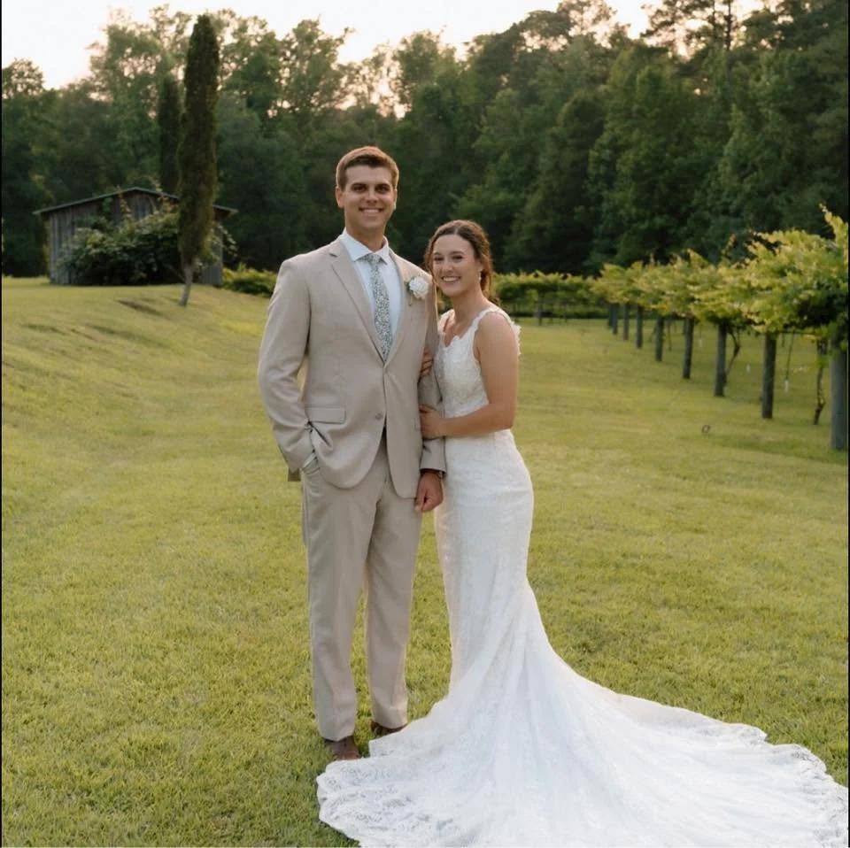 Ethan Warner and his wife outdoors on their wedding day